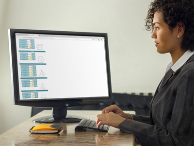 Photo of a woman working with an area and volume calculator on a desktop screen