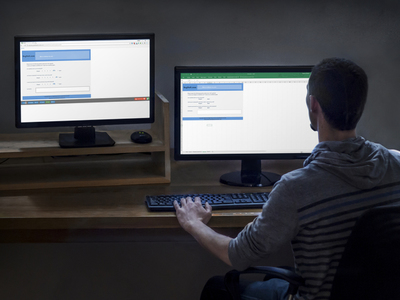 Photo of a man designing a survey on one screen and testing it on another