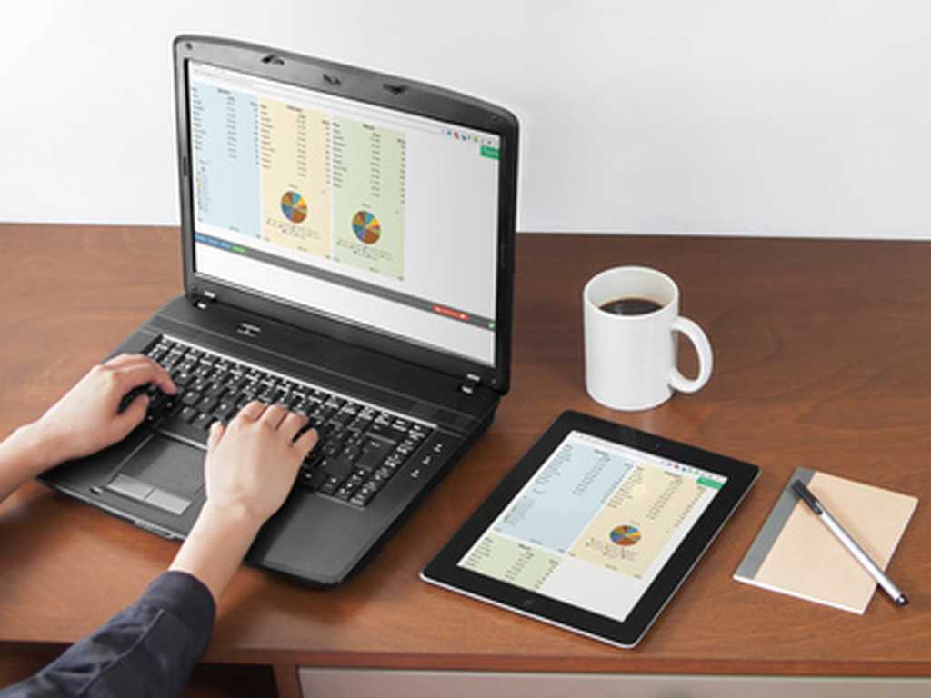 Photo of a laptop and tablet showing three and two columns of a calculator, respectively