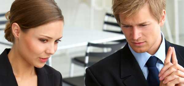 Photo of a Scandinavian couple frowning over a JavaScript calculator