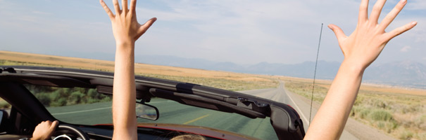 Photo of two arms reaching up from inside a cabriolet