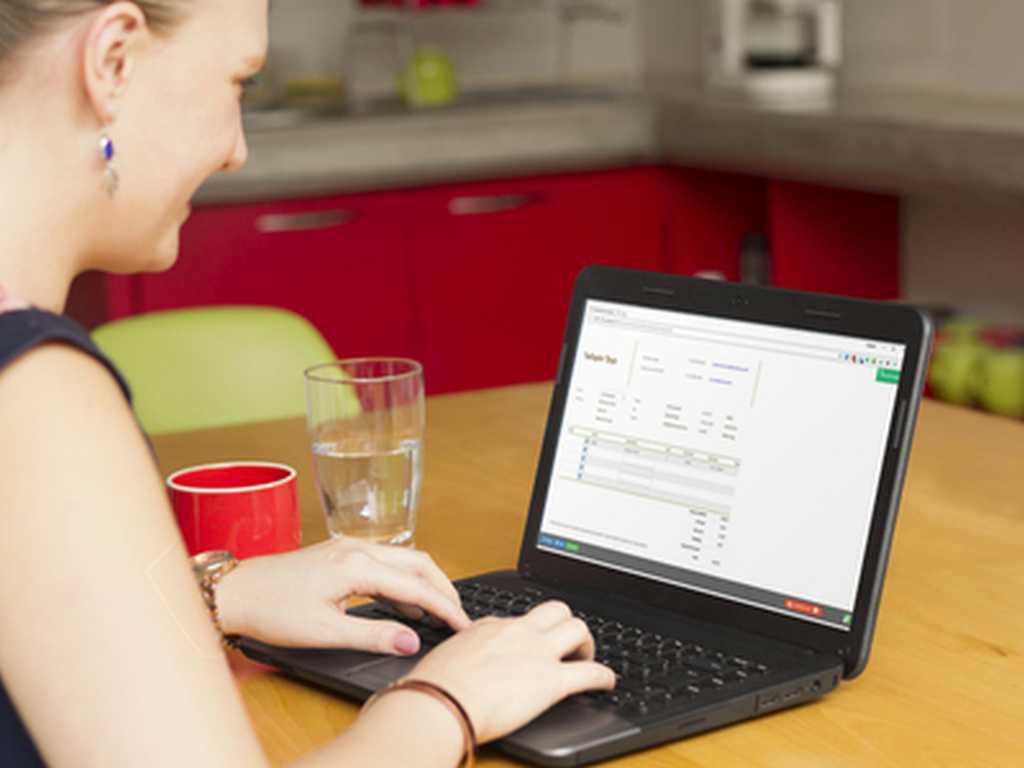 Photo of a woman working with an invoice on her coffee break