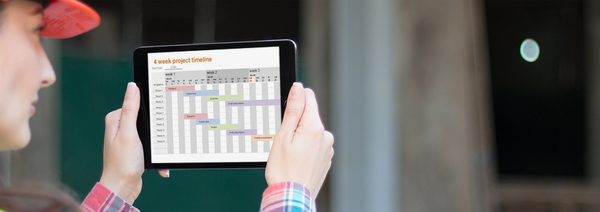 Photo of an engineer studying a project plan on an iPad tablet